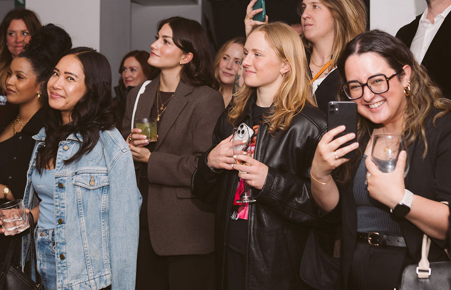 Group of women watching game taking pictures